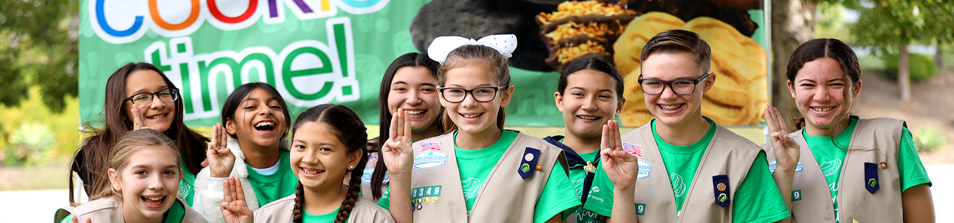  Girl Scouts in front of Cookie flag 