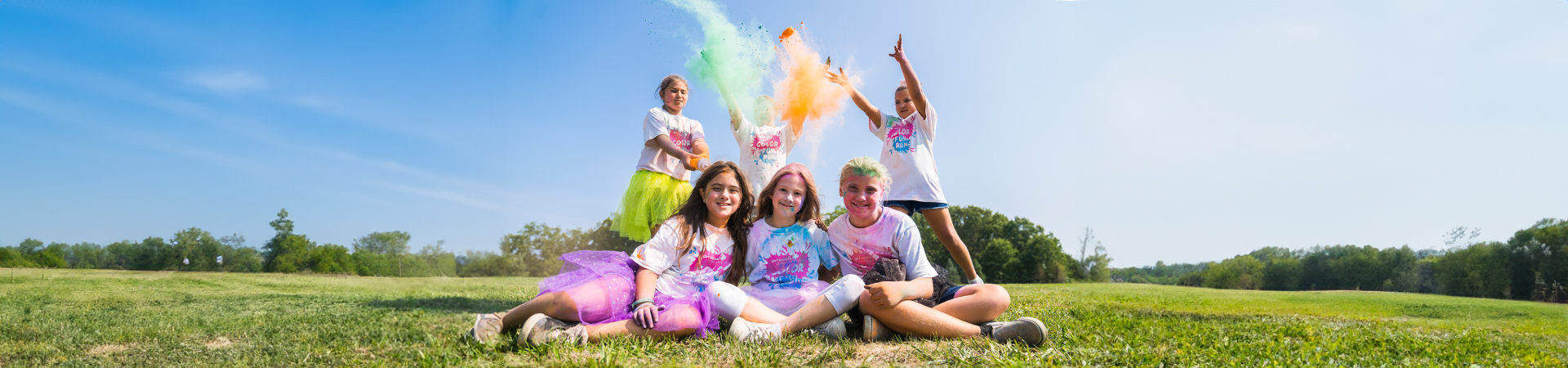  Group of girl scouts posing for a picture with color run chalk 