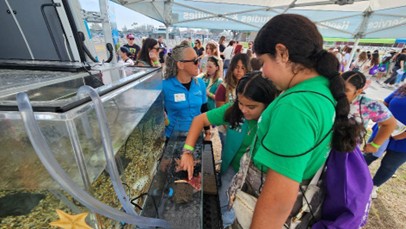 Under the Sea: Girl Scout Juniors learn about marine biology and get up close with a starfish at the Bolsa Chica Conservancy mobile touch tank.