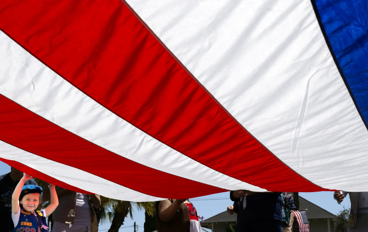 Four-year-old Remington Rivas holds Old Glory high as she and other Girl Scouts get ready to march in Anaheim’s 31st annual Flag Day parade on Sunday, June 14, 2026. (Photo by Mindy Schauer, Orange County Register/SCNG)